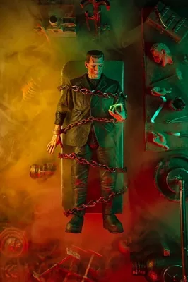 Frankenstein monster standing in a laboratory lit green and red