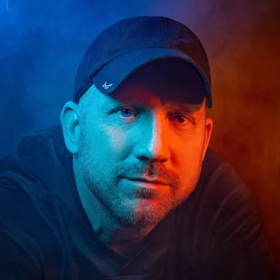 Portrait of Chuck Eiler, lit with blue and orange rim light