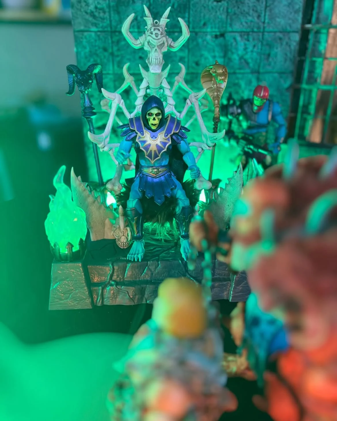 Behind the scenes view with blurred foreground figures and the lit set behind