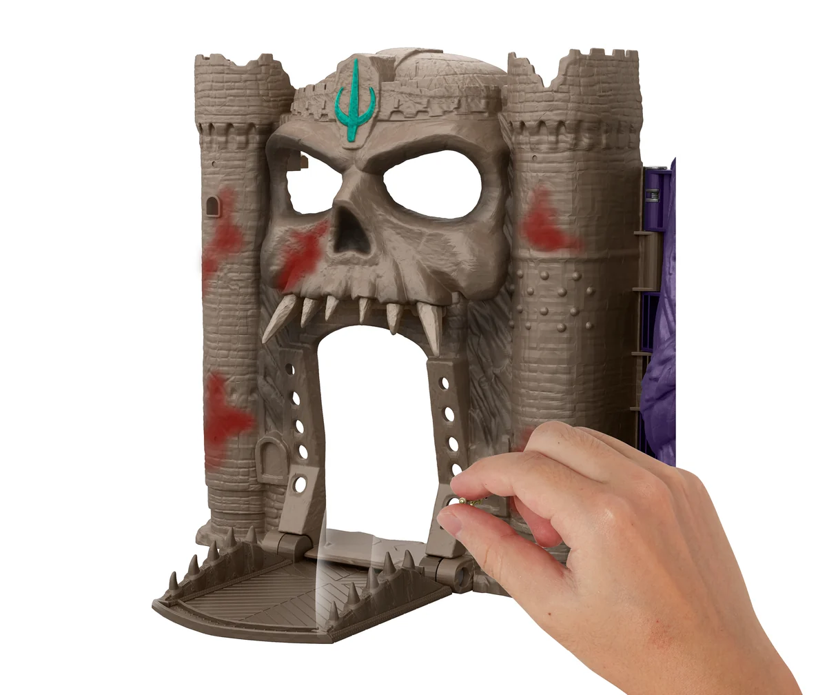 Hands operating the Jawbridge gate on the Castle Grayskull half