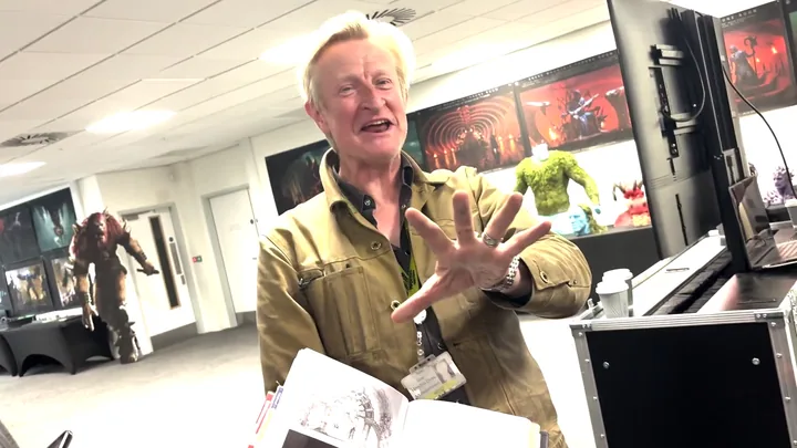 Dyas in the department, concept boards and a maquette along the wall behind him.