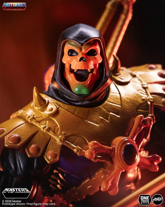 A close crop on the orange skull and the bone and orb chest harness, with the green wash across the crown clearly visible.