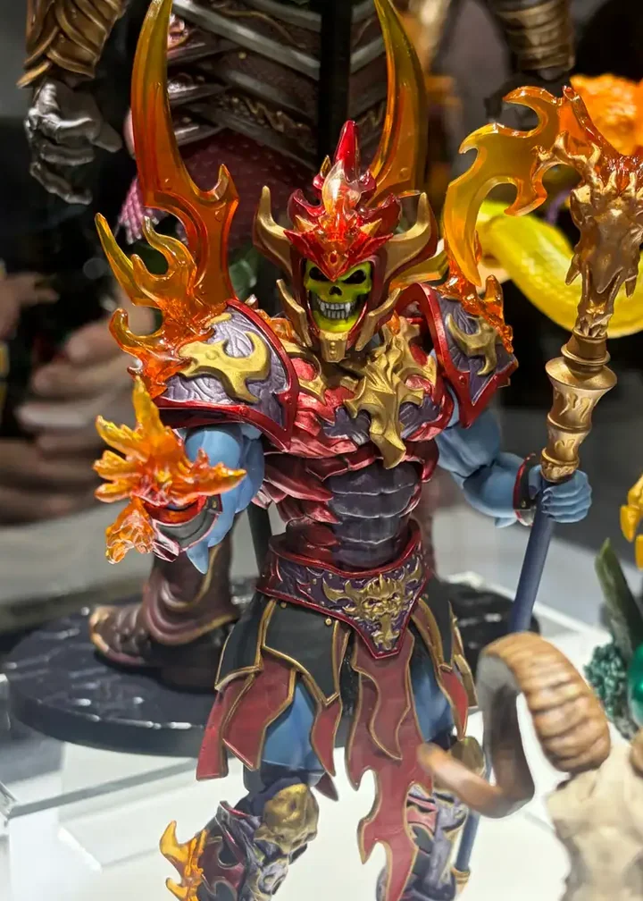 Fire Armor Skeletor in Mondo's display case at San Diego Comic-Con 2026, with translucent flame effects on the crown, pauldrons and staff.
