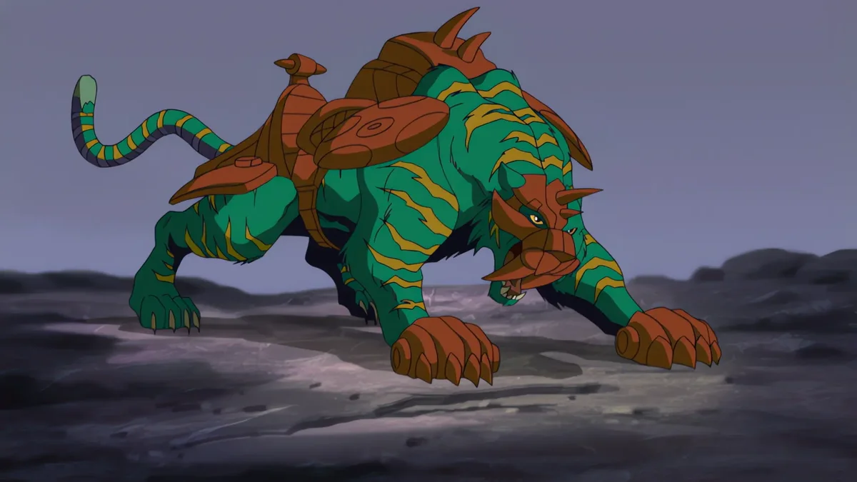 Battle Cat in the 2002 series design, green with orange stripes and orange armour, crouched low on a rocky grey ridge.