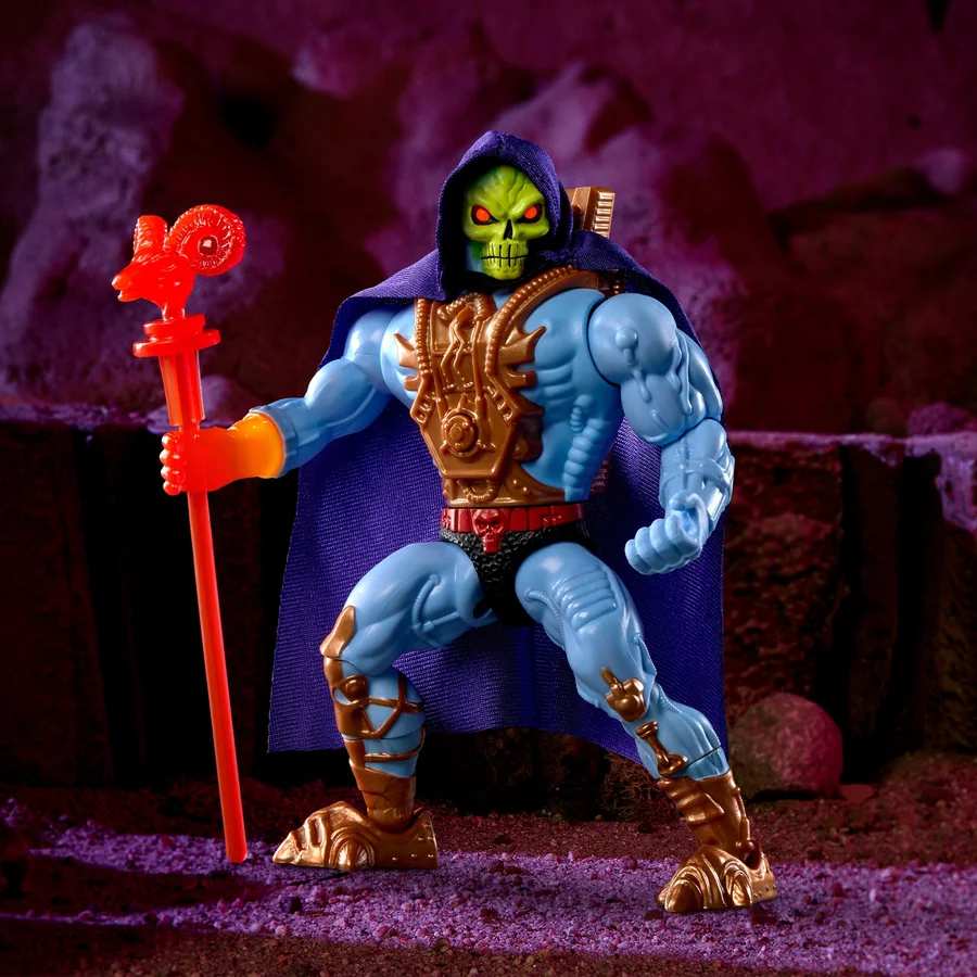 Laser Light Skeletor posed with his Havoc Staff on a purple Eternian rock face, his eye sockets burning red and the glow spilling out of his right wrist into the forearm.
