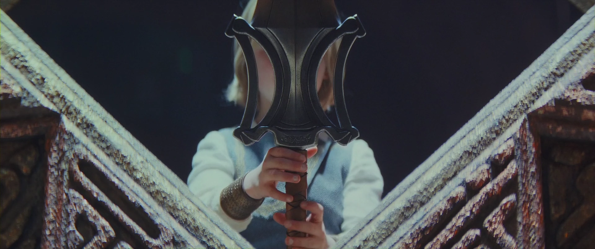 A ten-year-old Adam lifts the Power Sword the Sorceress has entrusted to him.