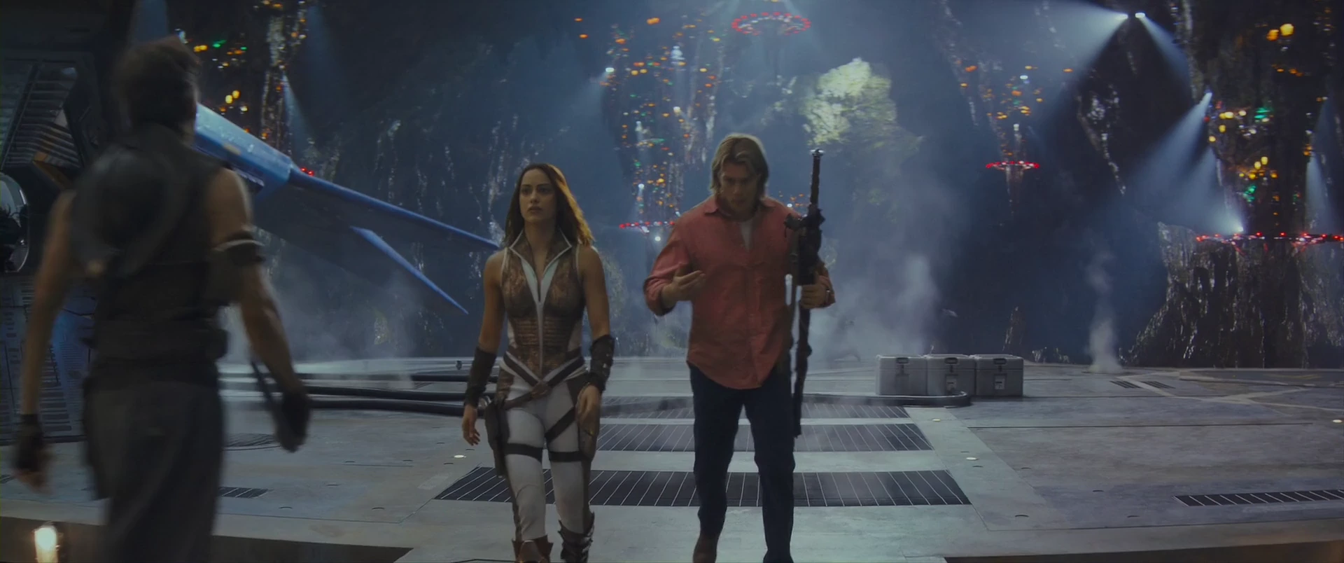 Adam takes up a rifle beside Teela as they prepare to fight for Eternia.