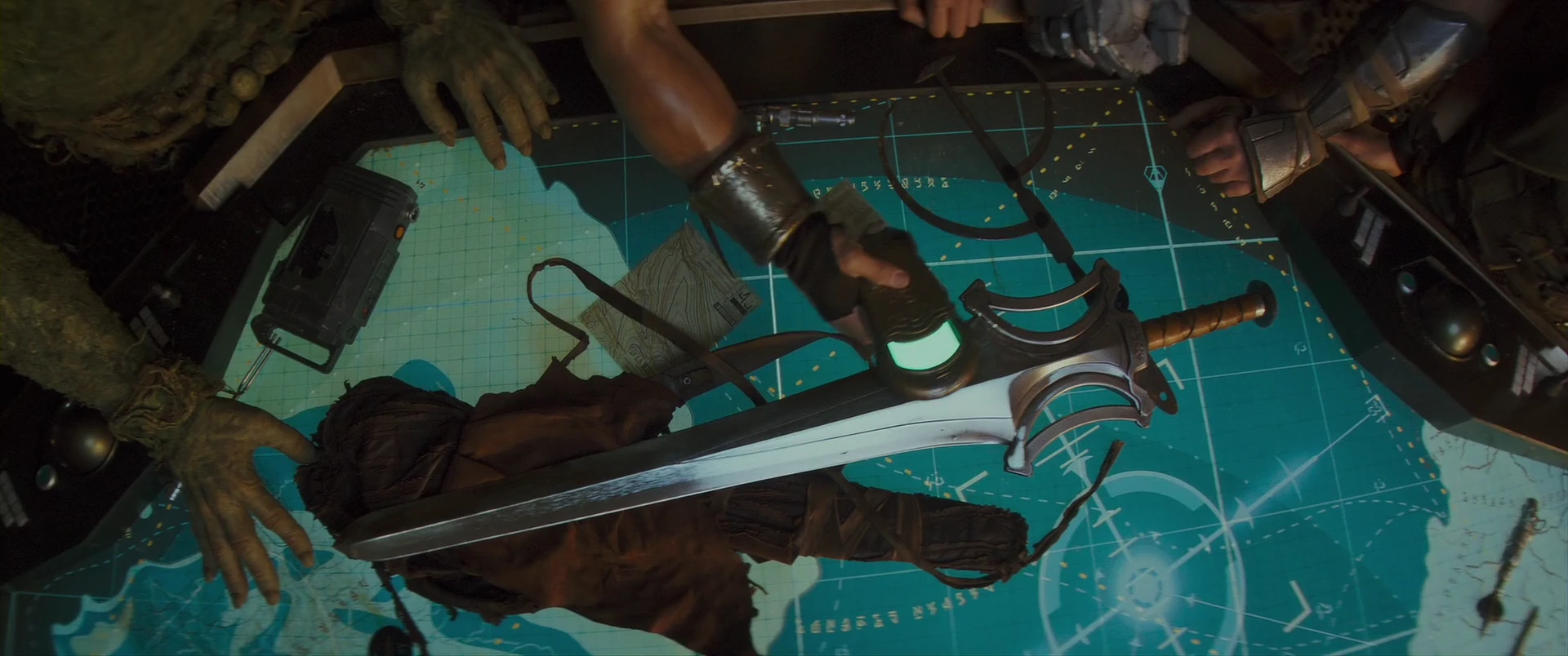 The Power Sword on the war table, the key to everything that follows.