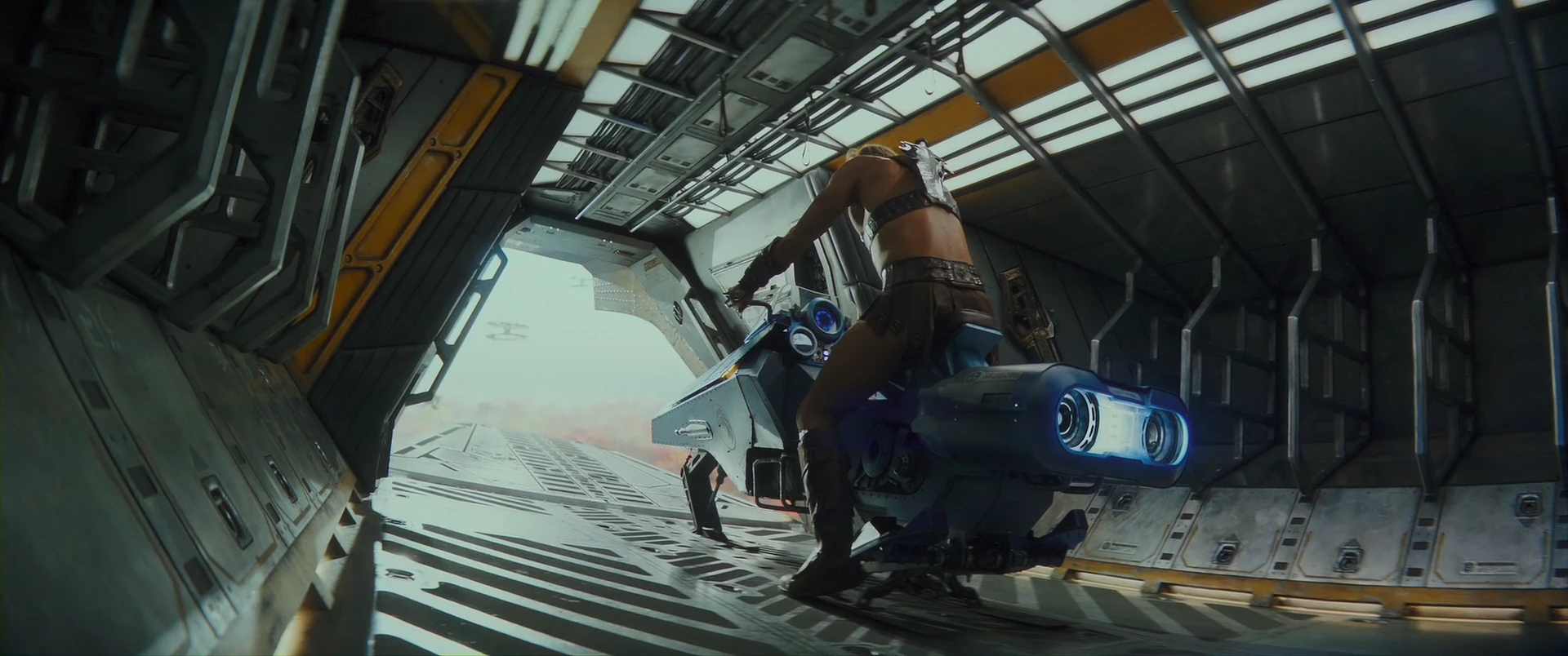 Teela readies a speeder bike in the cargo bay.