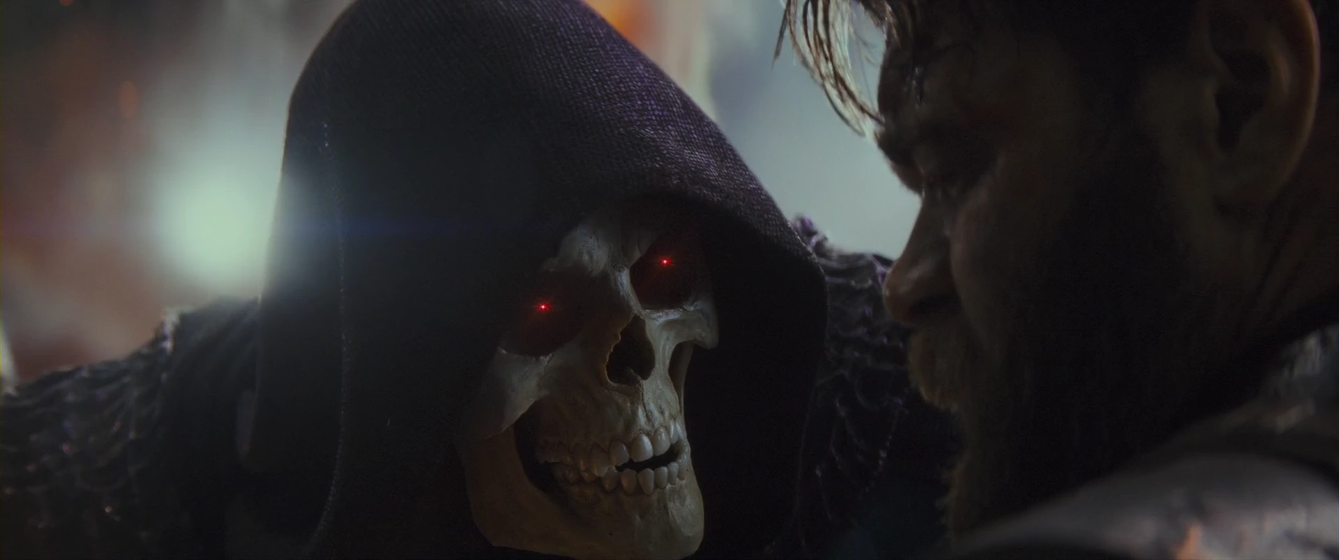 Skeletor leans in close, tormenting a captured warrior.
