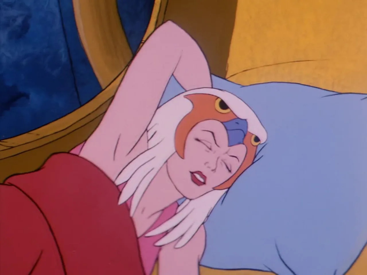 A white-haired woman with a bird-shaped headdress lies asleep against a pillow, stirring uneasily.