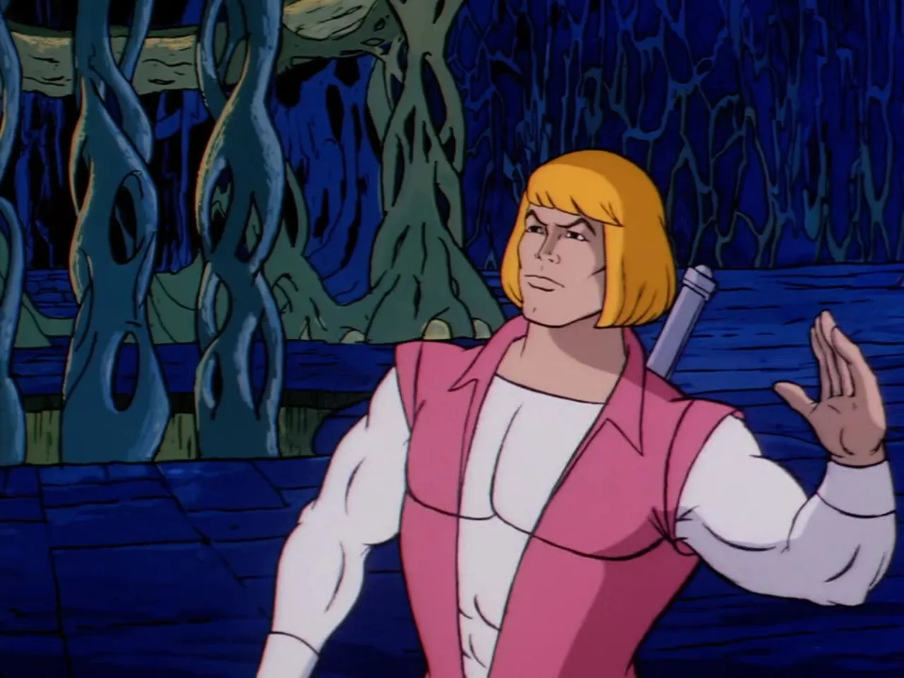 The domed pink palace city sits on its rocky cliff above the ocean in a wide establishing shot.