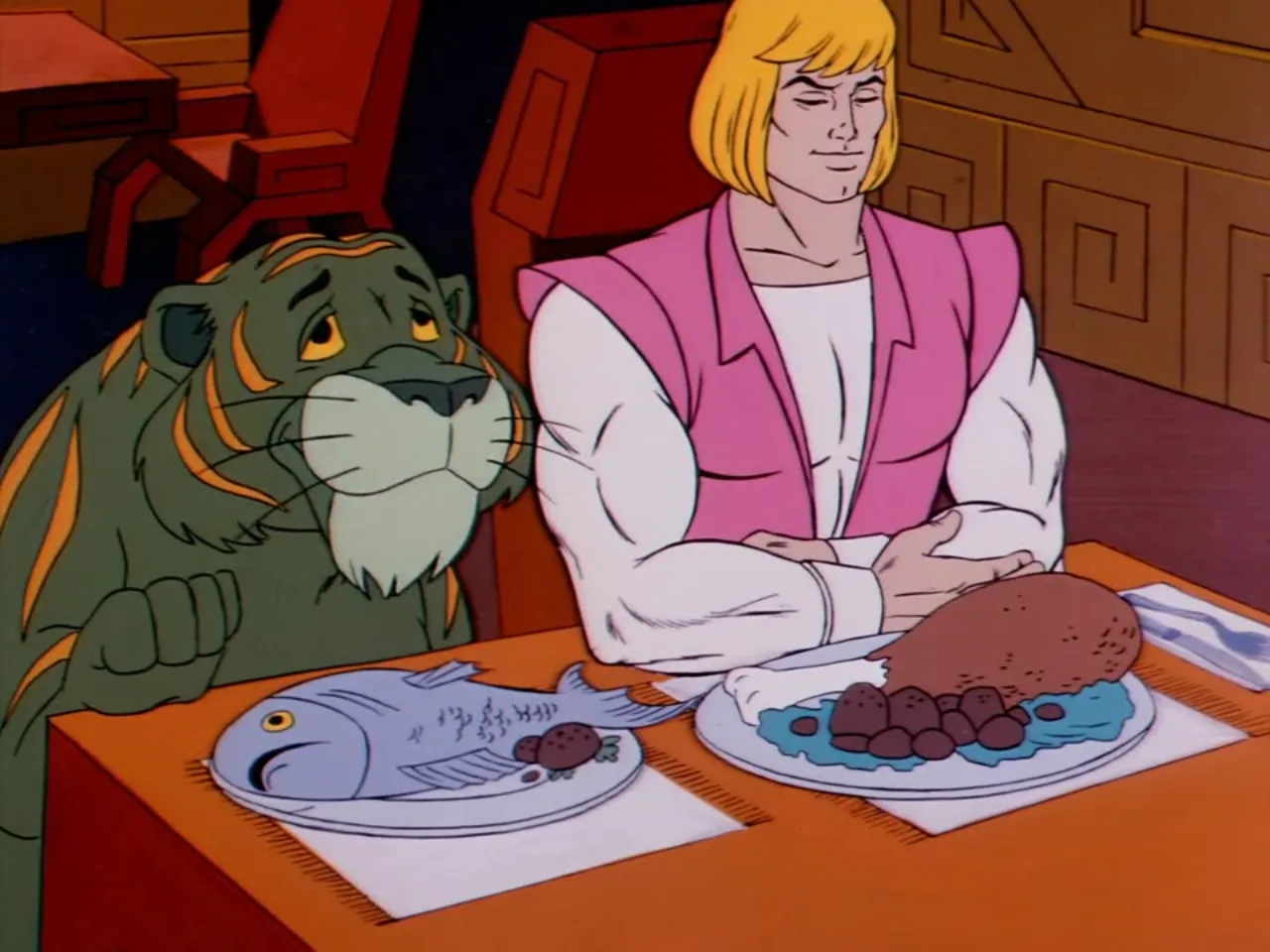 Adam sits at a dinner table smiling while Cringer eyes a fish dinner beside him.