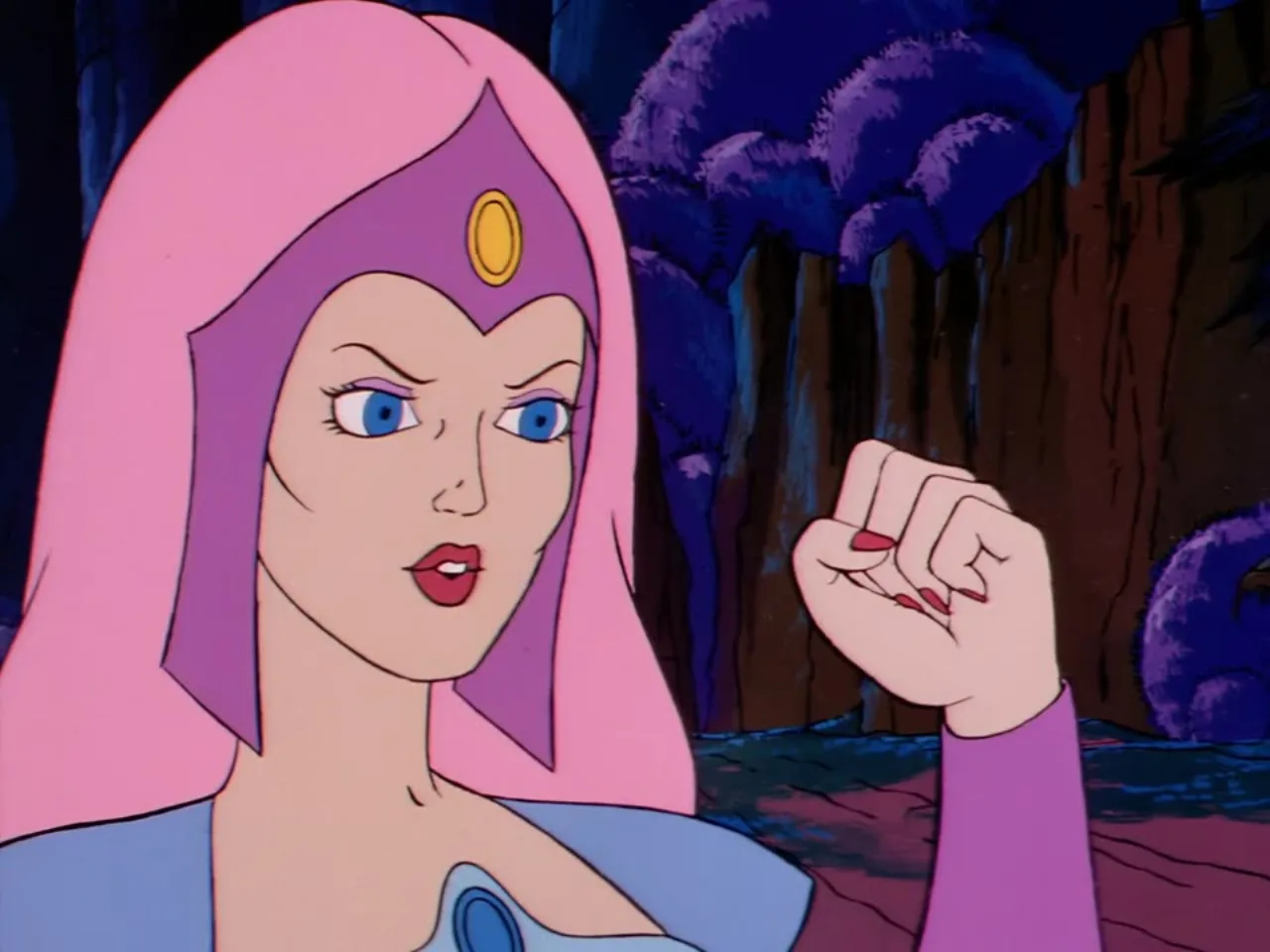 A pink haired woman raises a clenched fist while speaking urgently in close up.