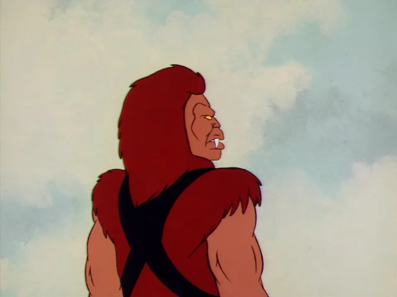 Beast Man snarls in profile against a cloudy sky baring his fangs