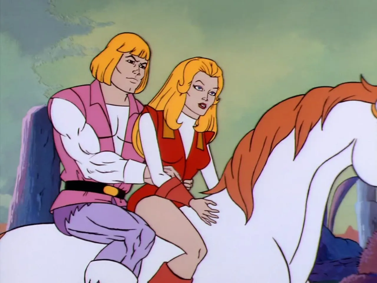 He-Man holds She-Ra's waist as they ride double on Swift Wind in a closer traveling shot.
