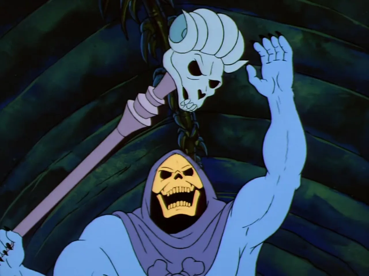 Skeletor raises his ram-skull Havoc Staff high overhead in a triumphant gesture.