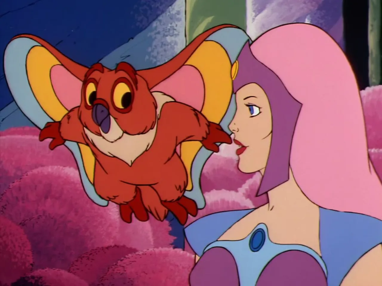 Kowl hovers close to Castaspella's face as she speaks amid the pink forest foliage.