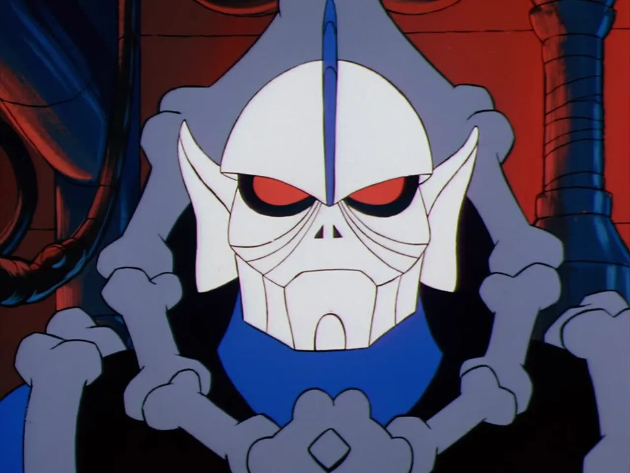 A white horned robotic skull face with glowing red eyes glares forward inside Hordak's fortress.