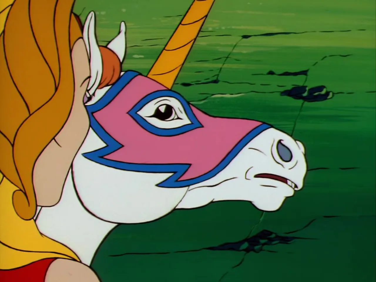 A close-up of Swift Wind's masked unicorn head shows his golden horn and pink markings.
