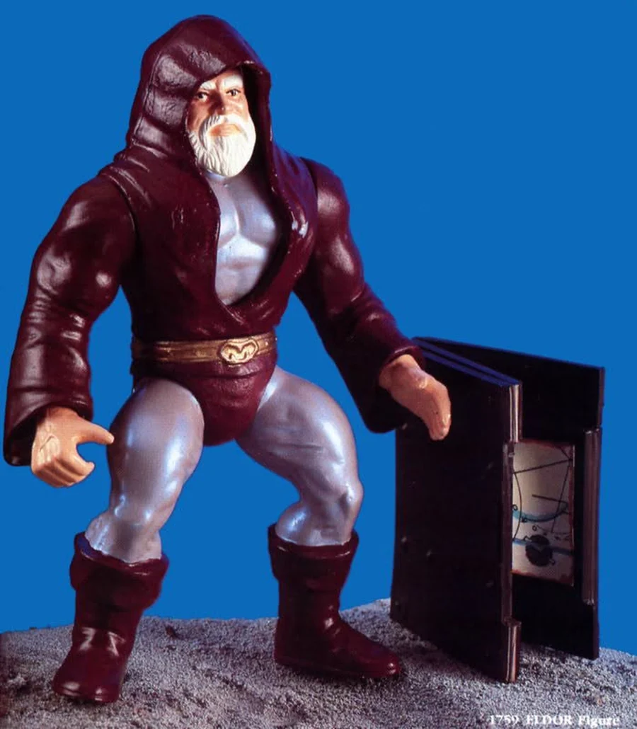 The unreleased 1980s Eldor prototype figure in a deep maroon robe with silver-grey limbs, holding an open book, photographed against a blue background and labelled 1759 ELDOR Figure.