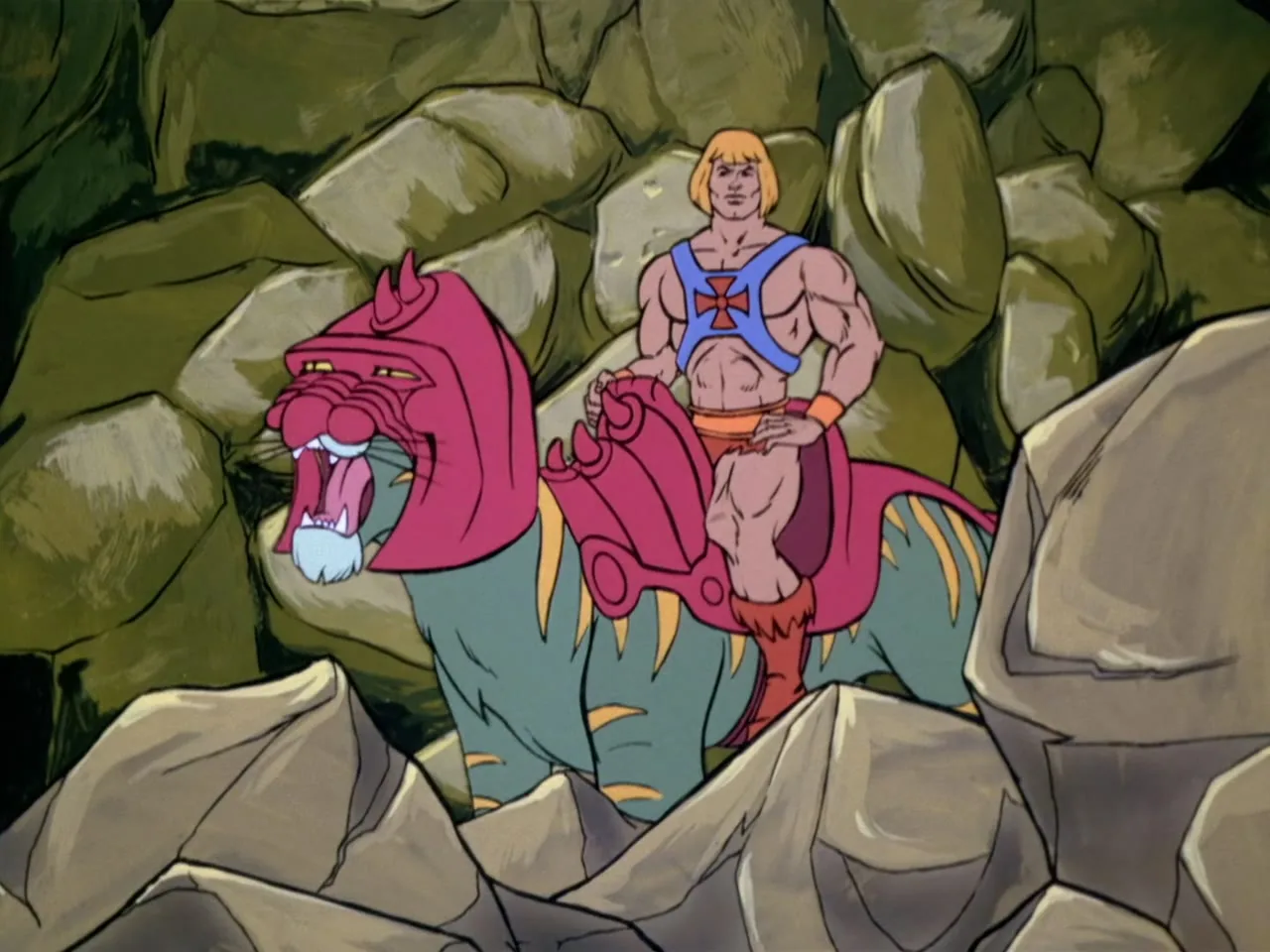 He-Man sits astride Battle Cat among large boulders, looking out calmly.