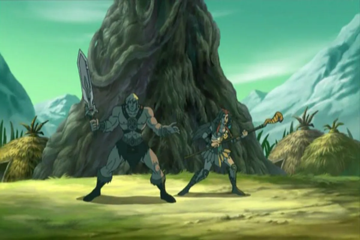 He-Man and Teela brace in a village clearing, ready to fight