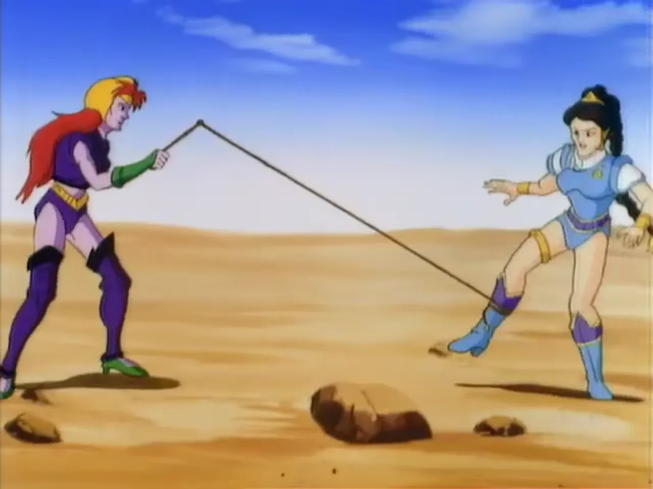 The red-haired woman and Mara face off on the desert, a whip stretched between them.