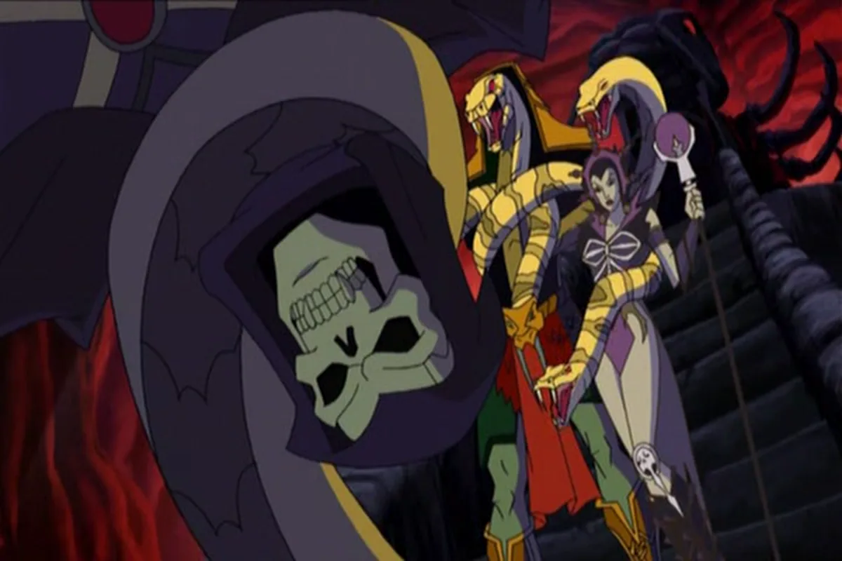 Skeletor, King Hsss and Evil-Lyn stand together on the stone steps