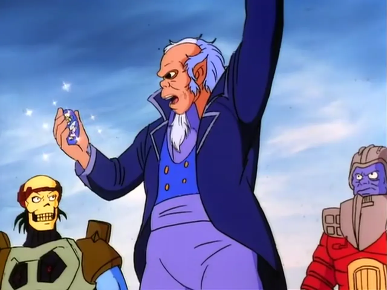 The old man holds up a glowing gem with one raised arm as Skeletor and Flogg watch.